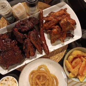 Cafe Evannah | 1KG BBQ Pork Ribs, 8 Winglets, Chips, Onion Rings, Coleslaw & Drinks for 2 People